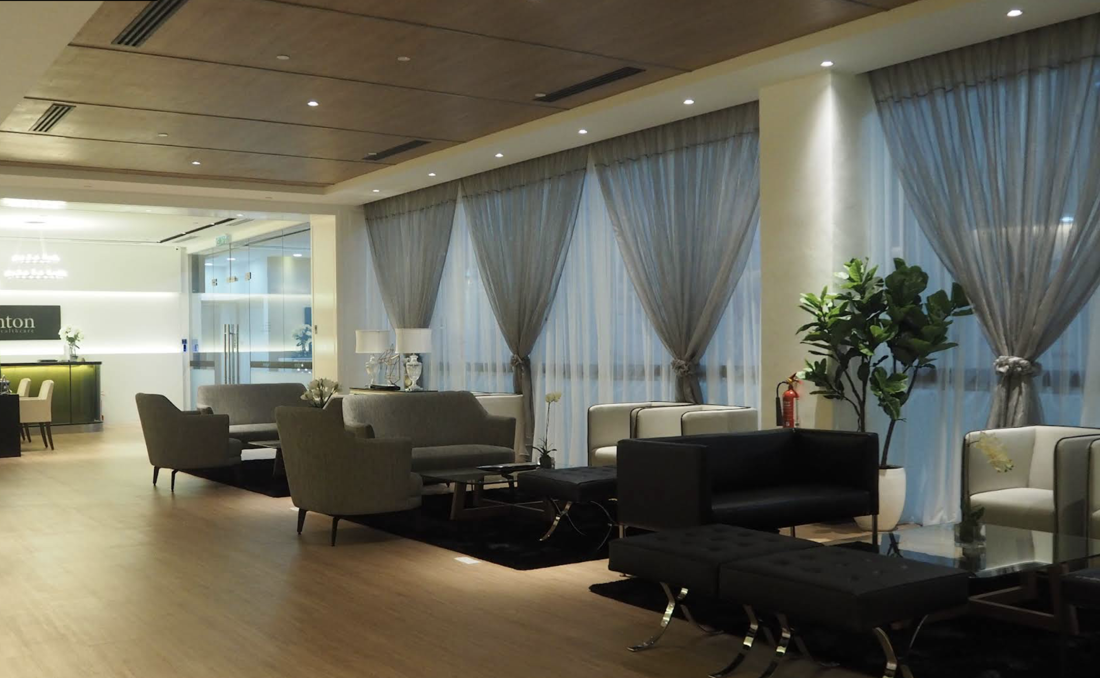 Brighton Healthcare lounge with comfortable seating and floor-to-ceiling windows